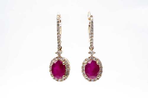 A pair of ruby and diamond earrings in 14 carat yellow gold