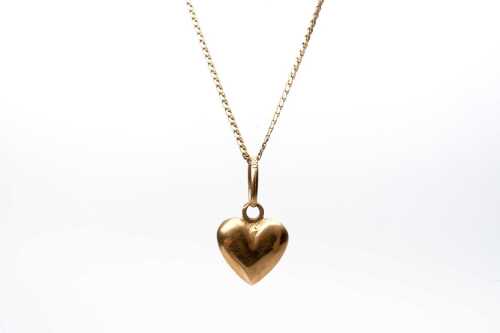 A heart pendant and necklace in 18 carat yellow gold