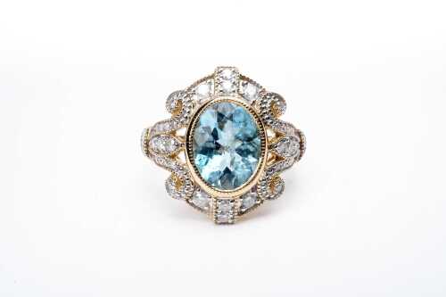 An aquamarine and diamond ring in 14 carat yellow gold