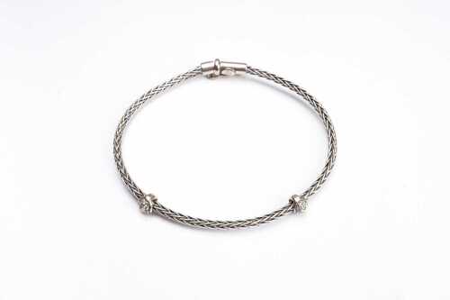 An Italian diamond set flexible bangle in 18 carat white gold