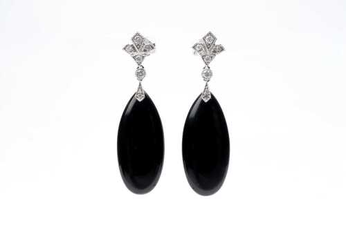 A pair of onyx and diamond earrings in 14 carat white gold