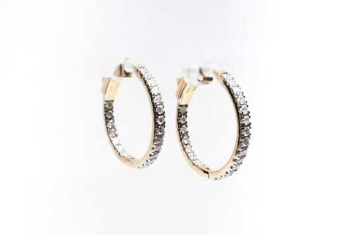 A pair of diamond hoops in 14 carat yellow gold