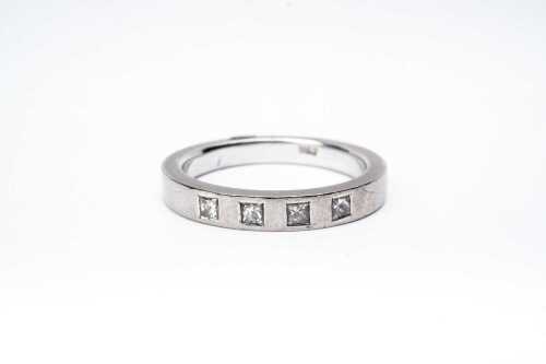 A princess cut diamond band in 18 carat white gold