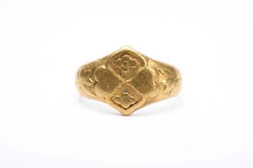 A carved signet ring in 24 carat yellow gold