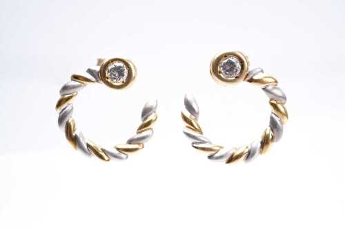 A pair of diamond earrings in 18 carat yellow and white gold