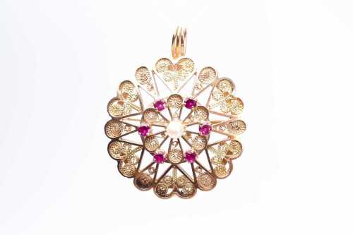 An ornate vintage ruby and pearl brooch/pendant in 14 carat yellow gold