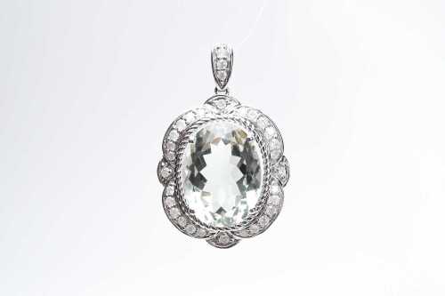 A green amethyst and diamond pendant in 10 carat white gold