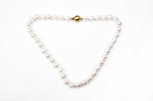 A strand of semi baroque pearls to a 9 carat ball clasp