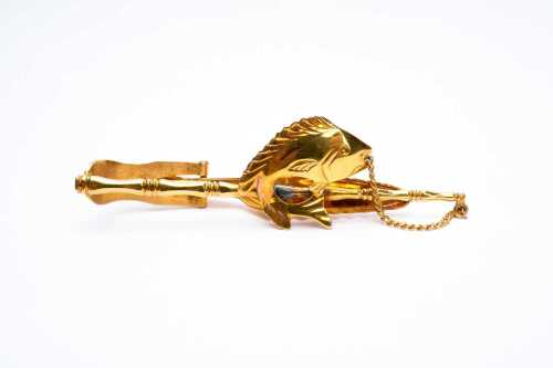A fish and rod tie bar in 14 carat yellow gold