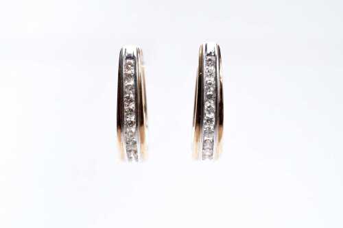 A pair of diamond hoops in 9 carat yellow gold