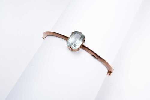 An antique aquamarine bangle in 9 carat rose gold