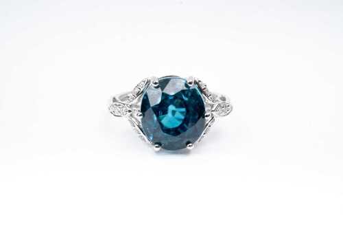 A blue topaz and diamond ring in 14 carat white gold