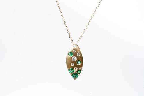 An emerald and diamond pendant and necklace in 14 carat yellow gold
