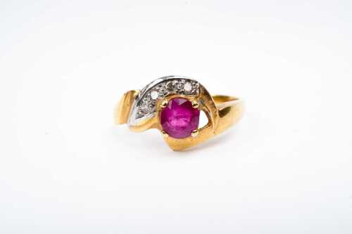 A ruby and diamond ring in 18 carat yellow gold