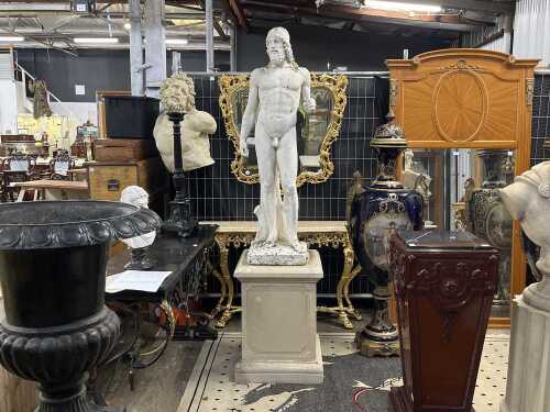 Classical style cast concrete statue of a male, on pedestal