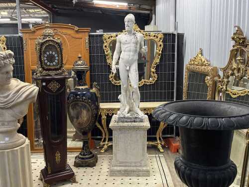 Classical style cast concrete statue of a male, on pedestal