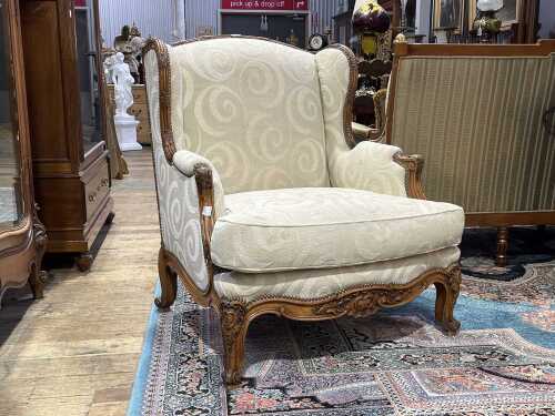 Antique French walnut wingback armchair