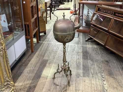 Antique brass kettle on stand