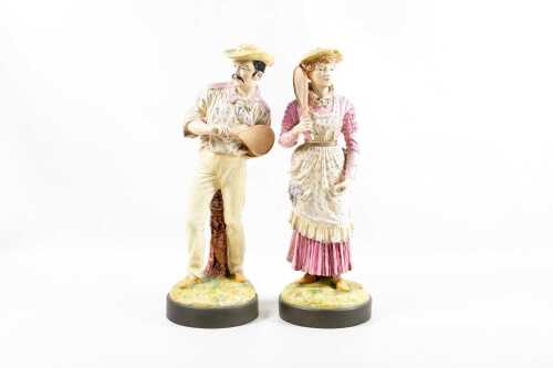 Pair of antique porcelain figures of tennis players