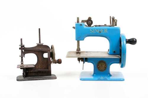 Two vintage hand crank miniature sewing machines including Singer