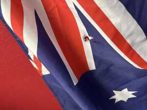 Two fabric Australian flags with timber poles. - 2