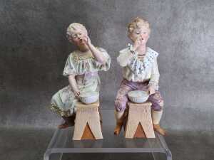 Pair of bisque porcelain boy and girl figures