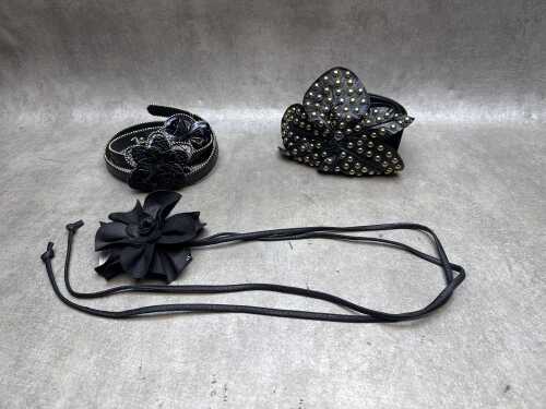 Three black leather and fabric floral belts