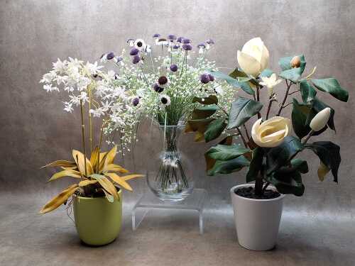 Three potted decorative artificial flowers