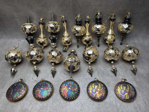 Christmas glass baubles in black and gold tones with glitter accents and religious icons