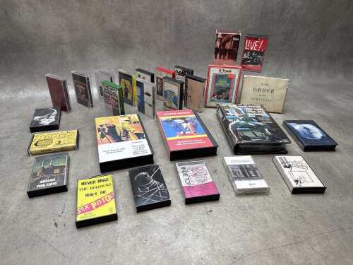 Music cassettes, including David Bowie VHS tapes and one Elvis 8-track cartridge