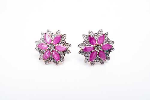 A pair of ruby and diamond earrings in 9 carat yellow gold