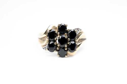 A onyx and diamond ring in 9 carat yellow gold