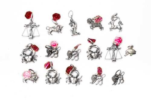 A collection of vintage zodiac sign charms in sterling silver