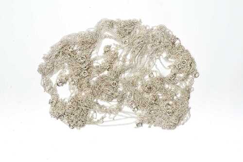 A large collection of curb link chains in sterling silver