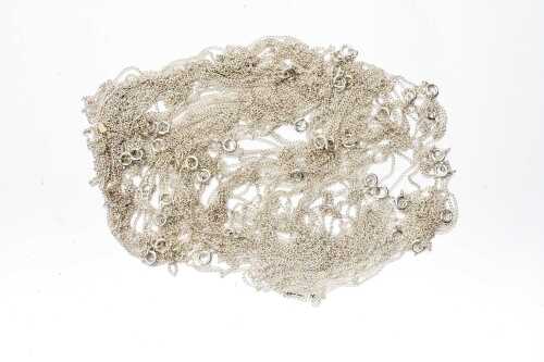 A large collection of curb link chains in sterling silver