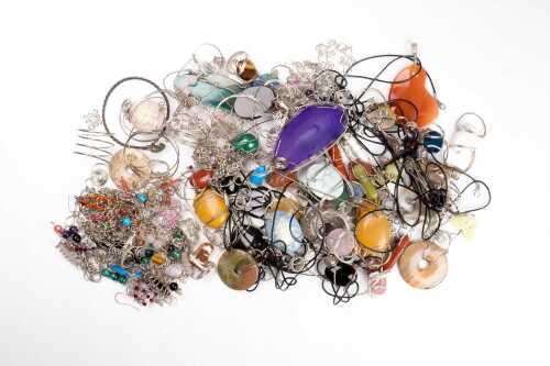 A large collection of stone set wirework jewellery in silver tone metal.