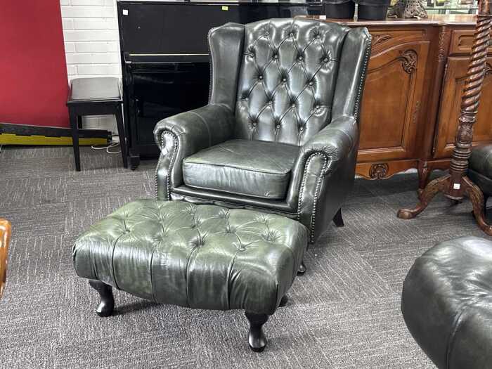 Green leather wingback Chesterfield chair with matching ottoman