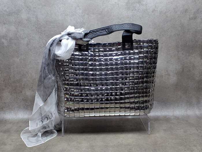Designer-style silver tone handbag with floral lining