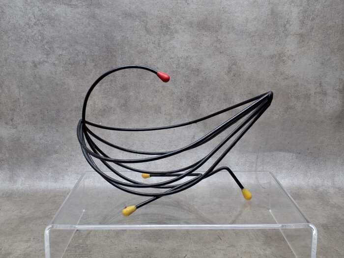 Mid-century black wire fruit basket with yellow and red tips.