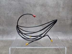 Mid-century black wire fruit basket with yellow and red tips.