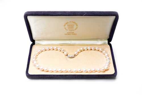 A strand of cultured pearls to a silver clasp