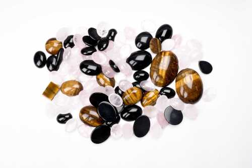 A large collection of rose quartz, tigers eye, and onyx
