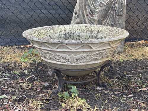 A decorative concrete water bowl