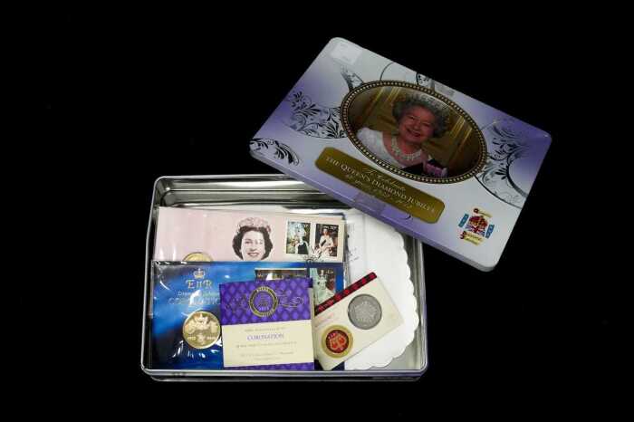 Tin of Royal Philatelic Numismatic Covers and collectable coins