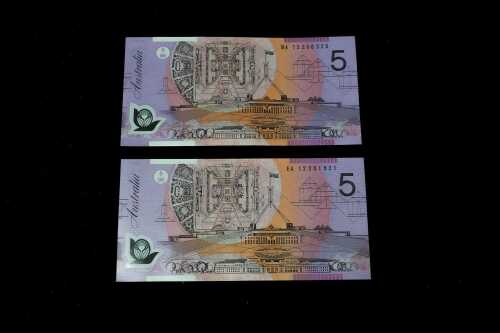 Two Australian polymer 2012 $5 notes, first and last release prefixes.