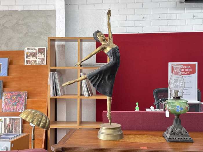 Art Deco-style brass figural dancer with black accents