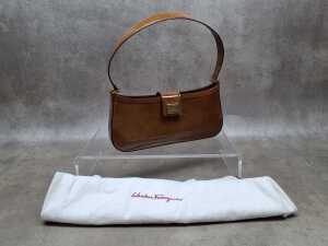 Designer-style brown patent leather shoulder bag with suede lining.