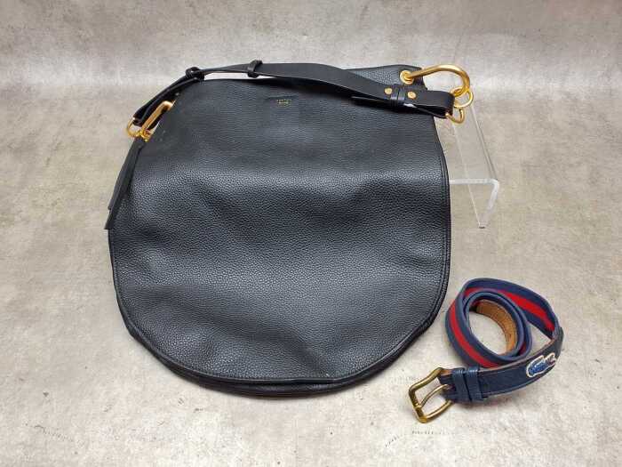 Designer-style handbag in black with gold tone hardware and red and blue belt
