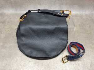Designer-style handbag in black with gold tone hardware and red and blue belt