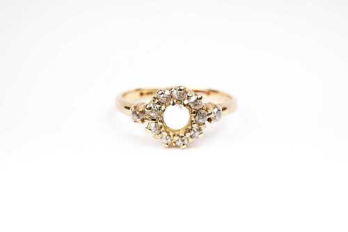A diamond ring setting in 18 carat yellow gold